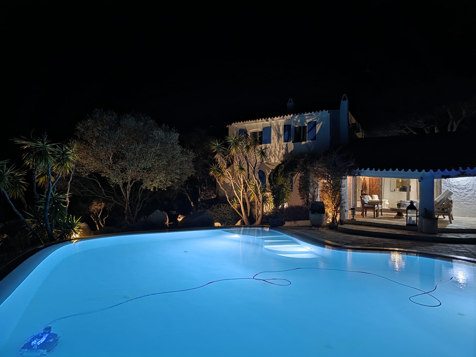 Night time illuminated villa and pool