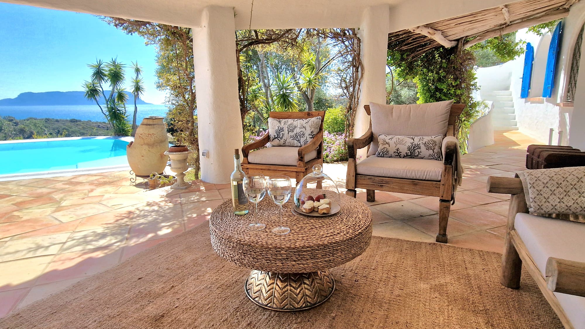 Shaded pergola and outside cushioned chairs