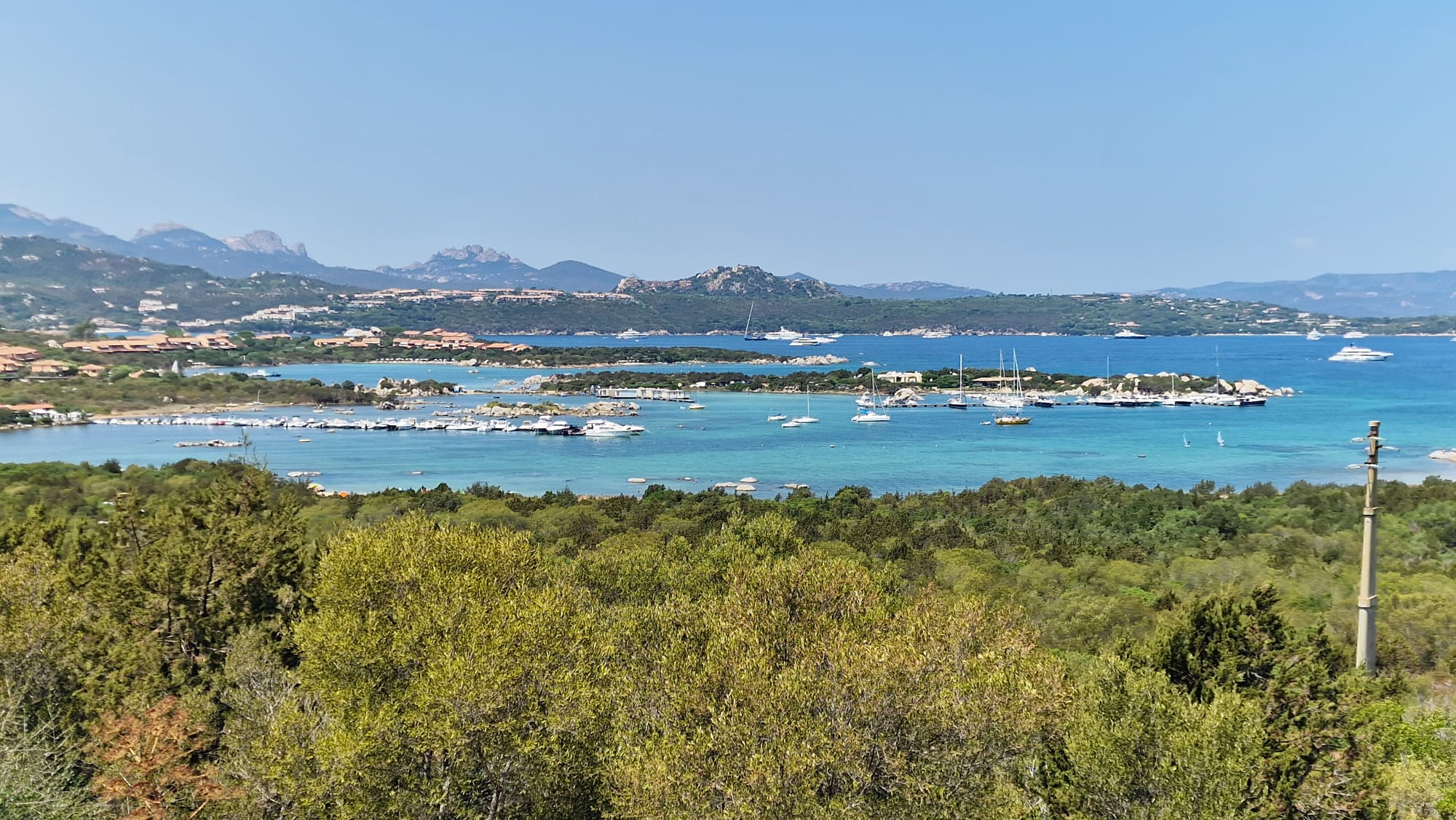Poolside panorama of the sea and mountains.